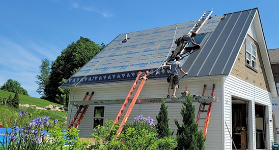 Photo of workers roofing a Vermont home